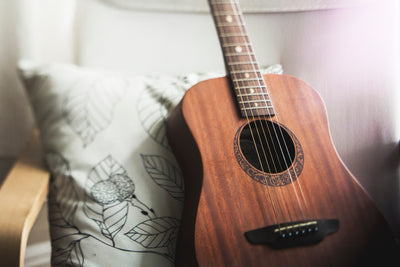 A guitar in a bedroom