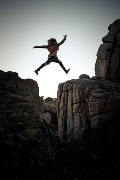 Someone leaping between rocks, visual representation of how it feels trusting in God
