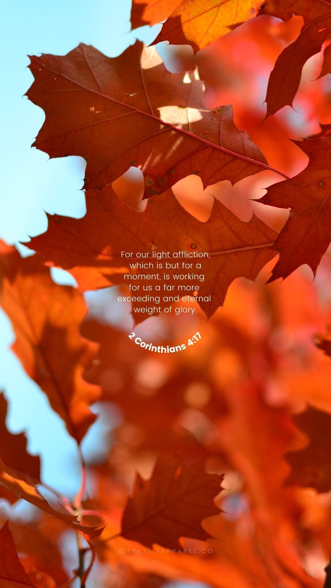 Autumn leaves with a biblical verse overlay on a blurred background