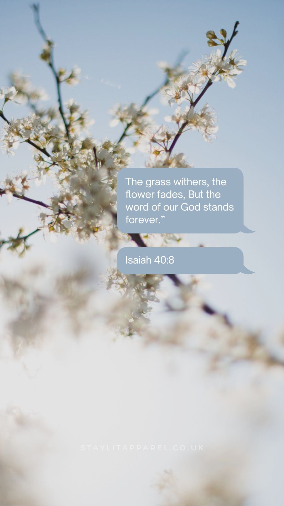 Floral branch with a blue text box containing the quote 'The grass withers, the flower fades; But the word of our God stands forever.' from Isaiah 40:8 on a blurred natural background.