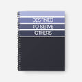 Notebook with 'Destined to Serve Others' text on a white background