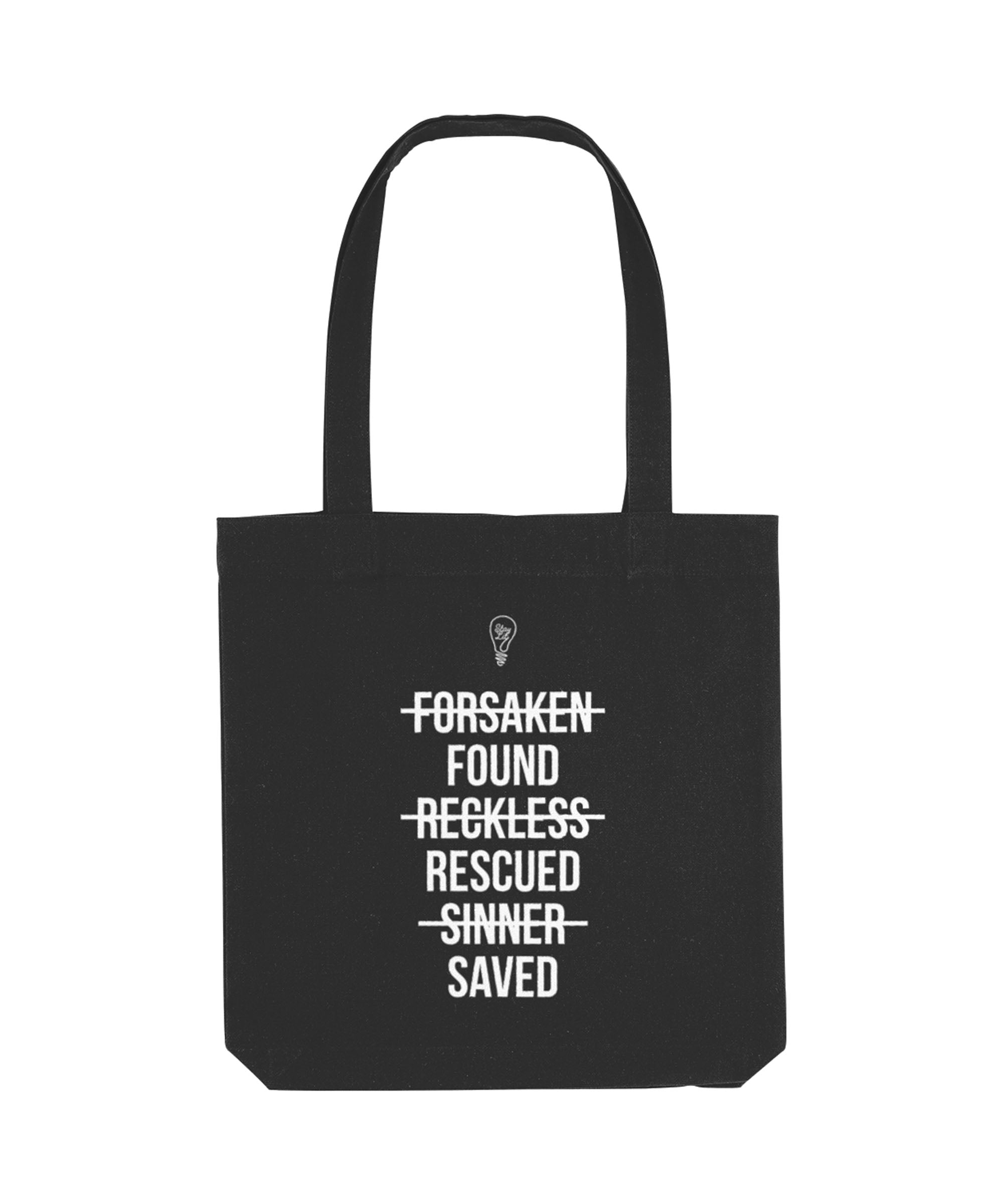 Black tote bag with white text on a white background