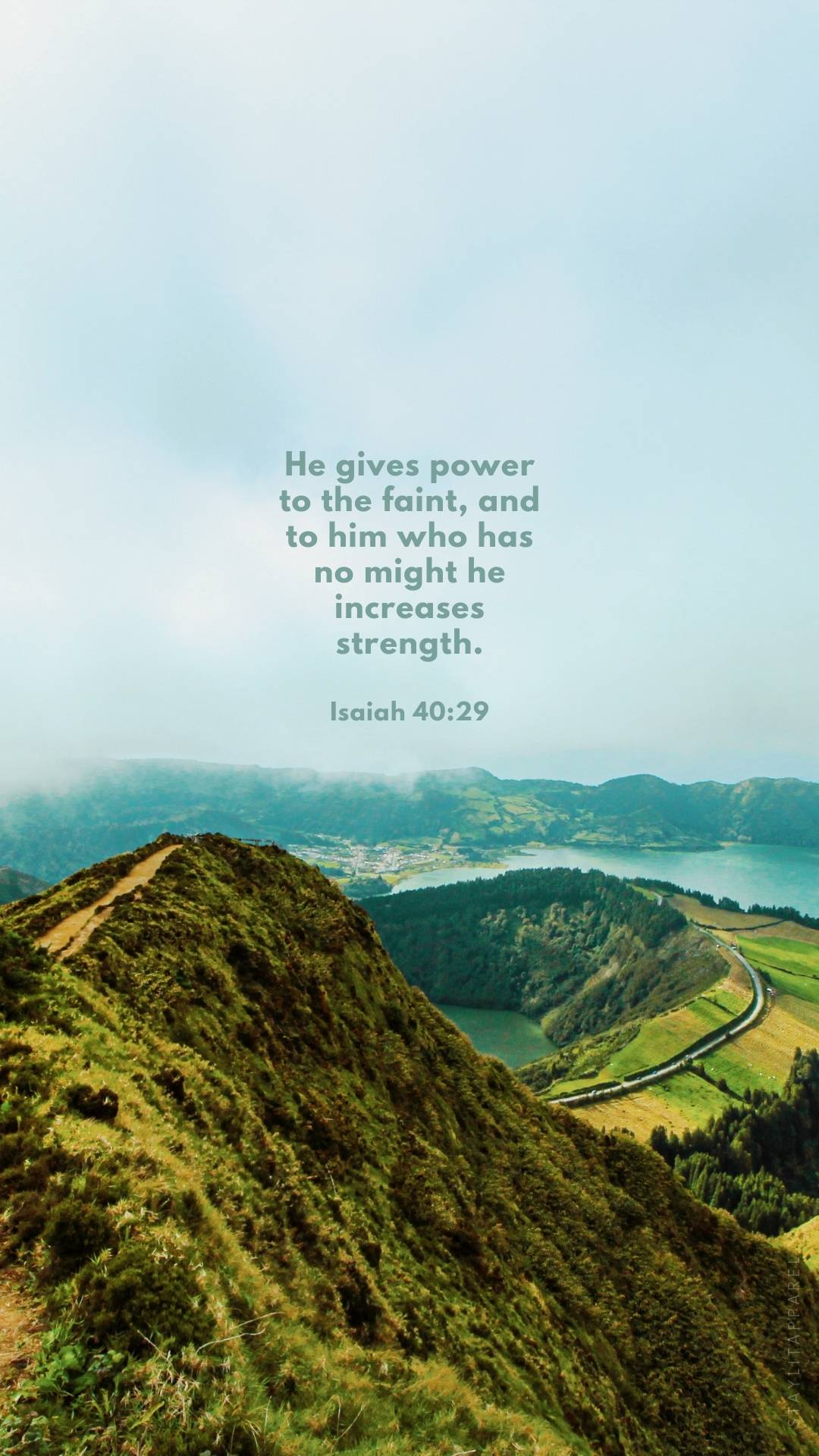 Isaiah 40:29 Bible verse over lush green mountain landscape, included in 16 Bible Verses About God's Mighty Power | Free Download phone backgrounds.