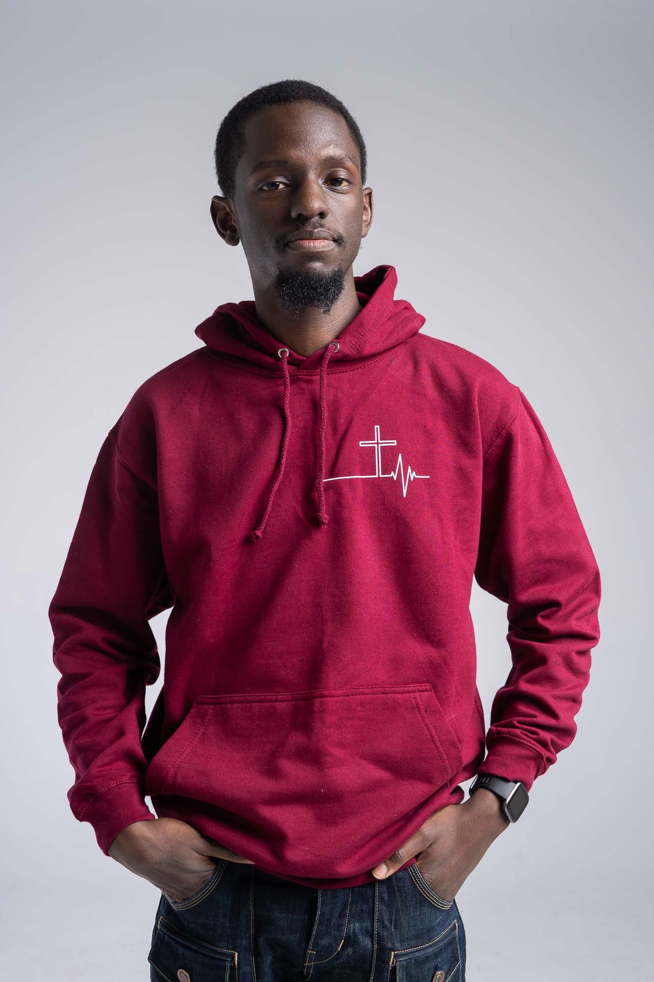 A person wearing the Stay Lit Apparel Jesus is my lifeline hoodie in burgundy