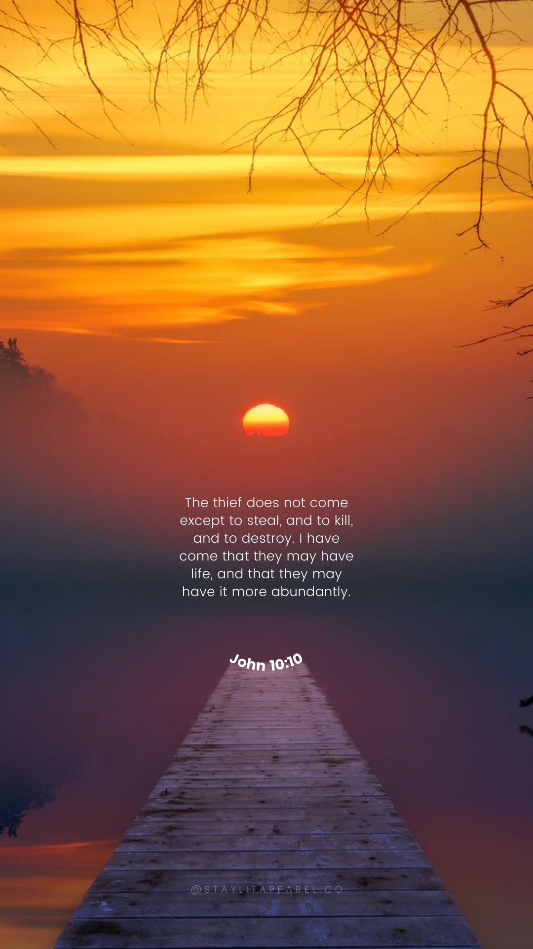 Sunset over a dock with a religious quote on a smartphone screen