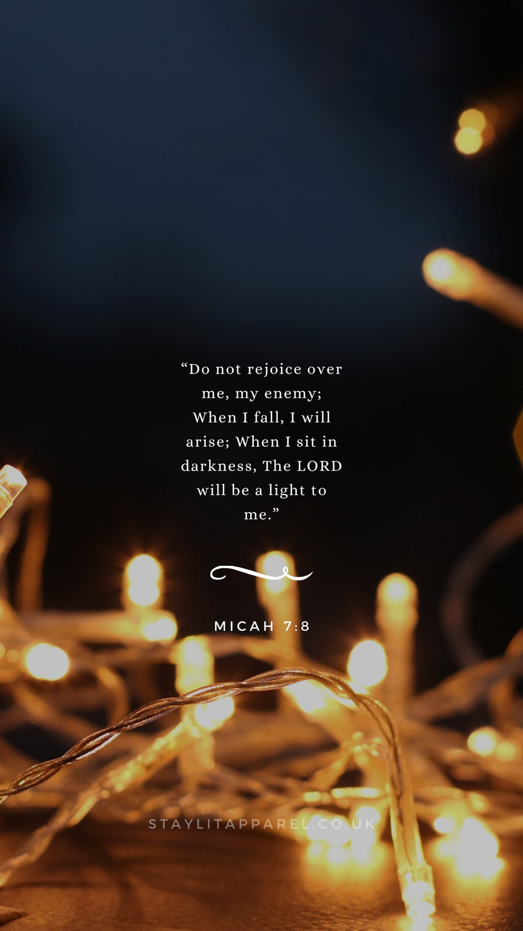 String lights and candles with a quote from Micah 7:8 on a dark background