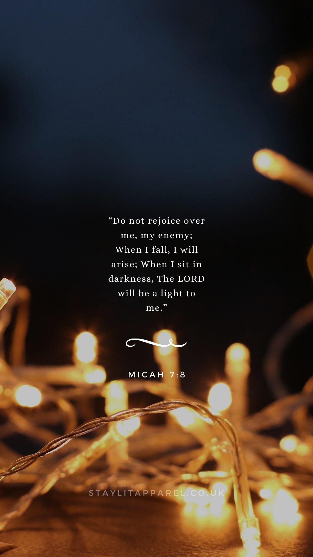 String lights and candles with a quote from Micah 7:8 on a dark background
