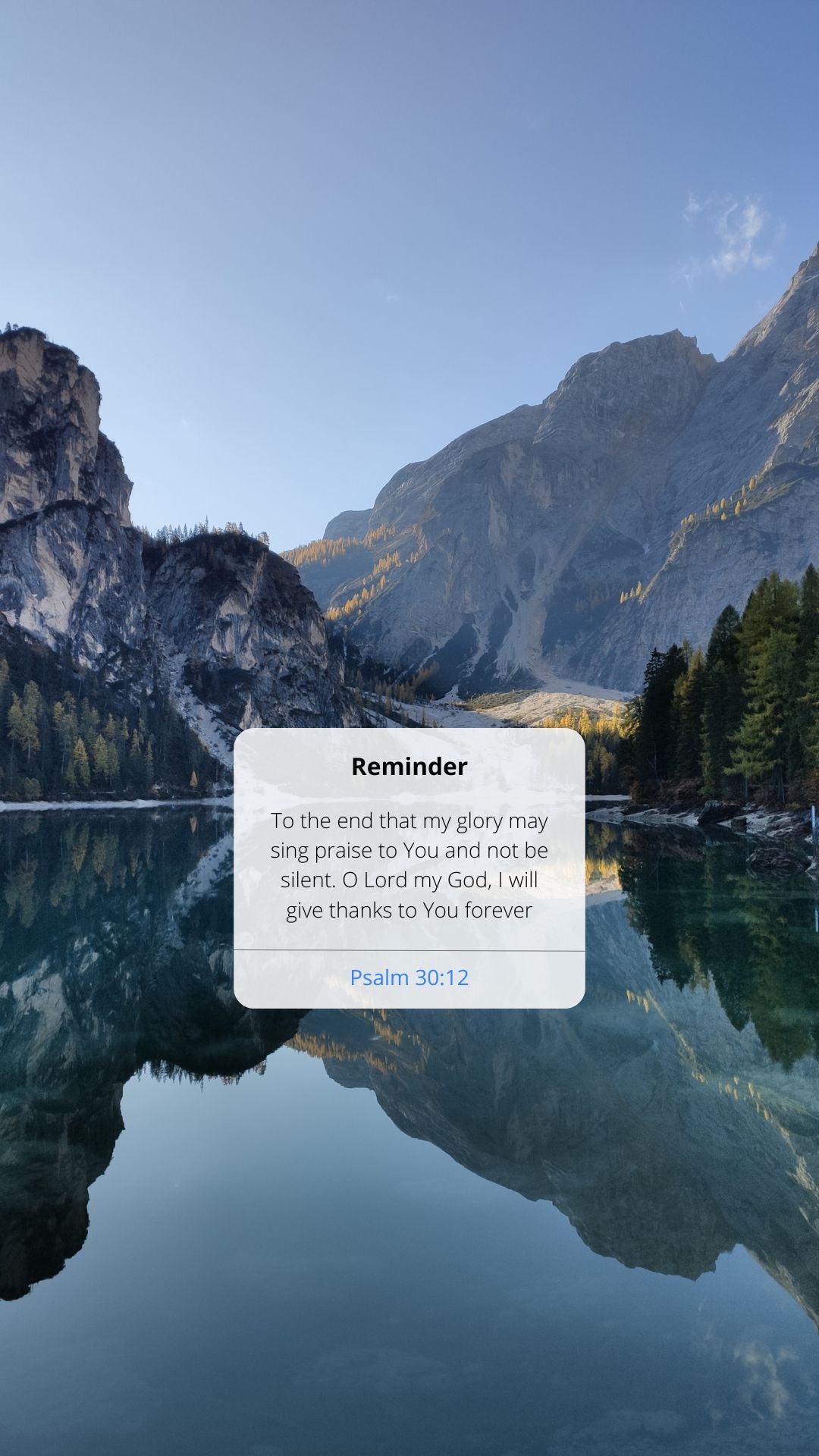 Mountainous landscape with a reflective lake and a text overlay on a white card.